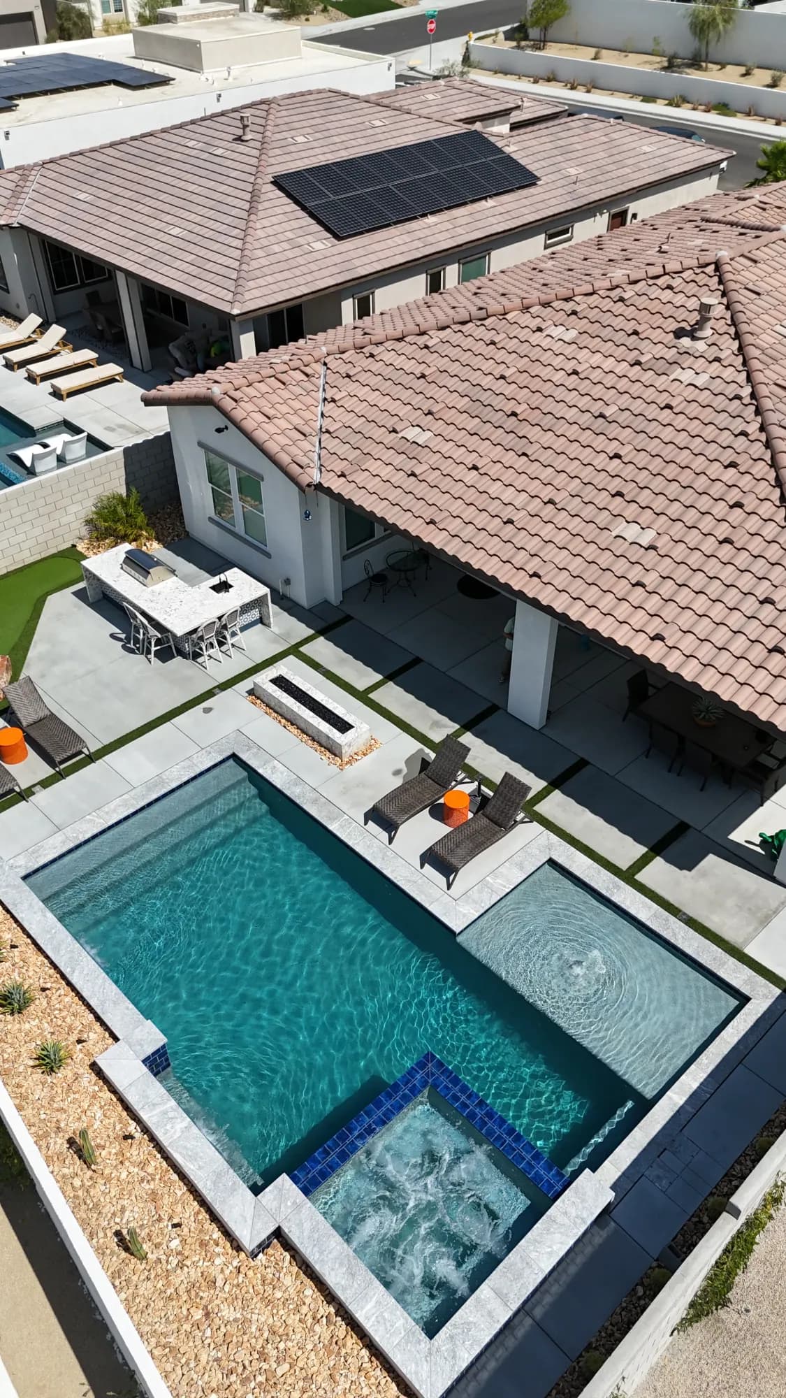 Aerial view showing how a custom pool, spa, and outdoor areas connect to the home