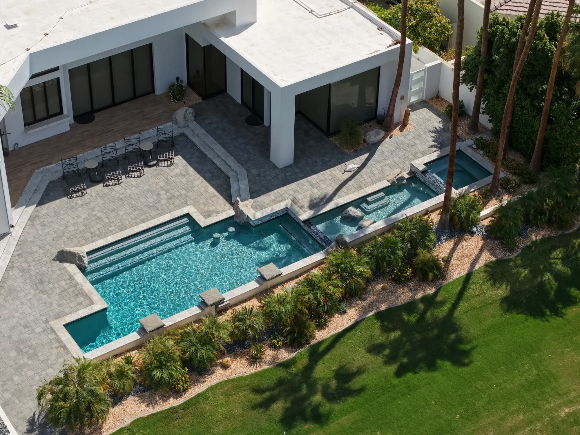 Aerial view showing how a custom pool, spa, and outdoor areas connect to the home