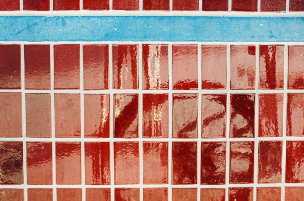 Red and blue mosaic tiles with white grout