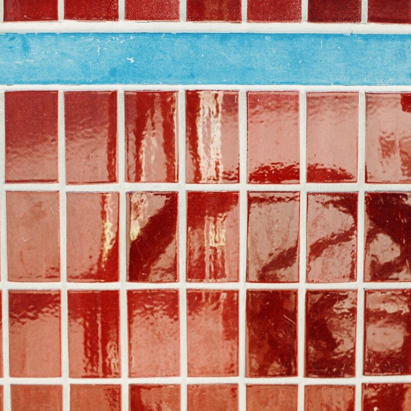 Red and blue mosaic tiles with white grout